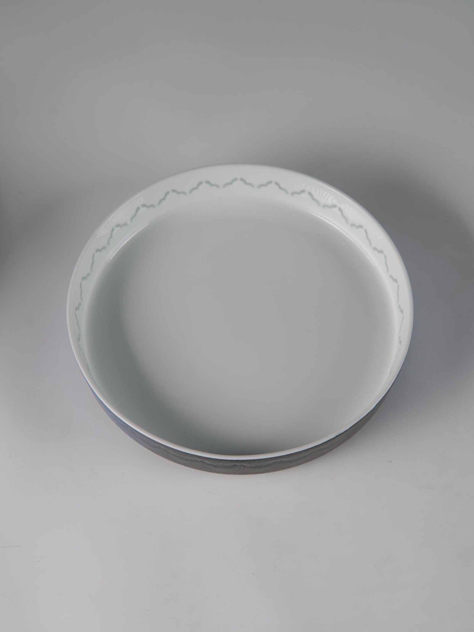 Carved Linglong Porcelain Plate – Top View Top down view of round porcelain plate showing inner surface and translucent edge