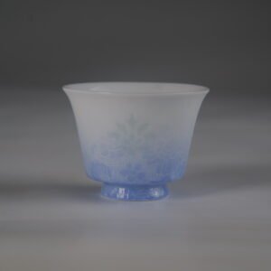 Front view of the East Breaking Dawn gradient blue horseshoe porcelain cup with fine embossed guilloche patterns