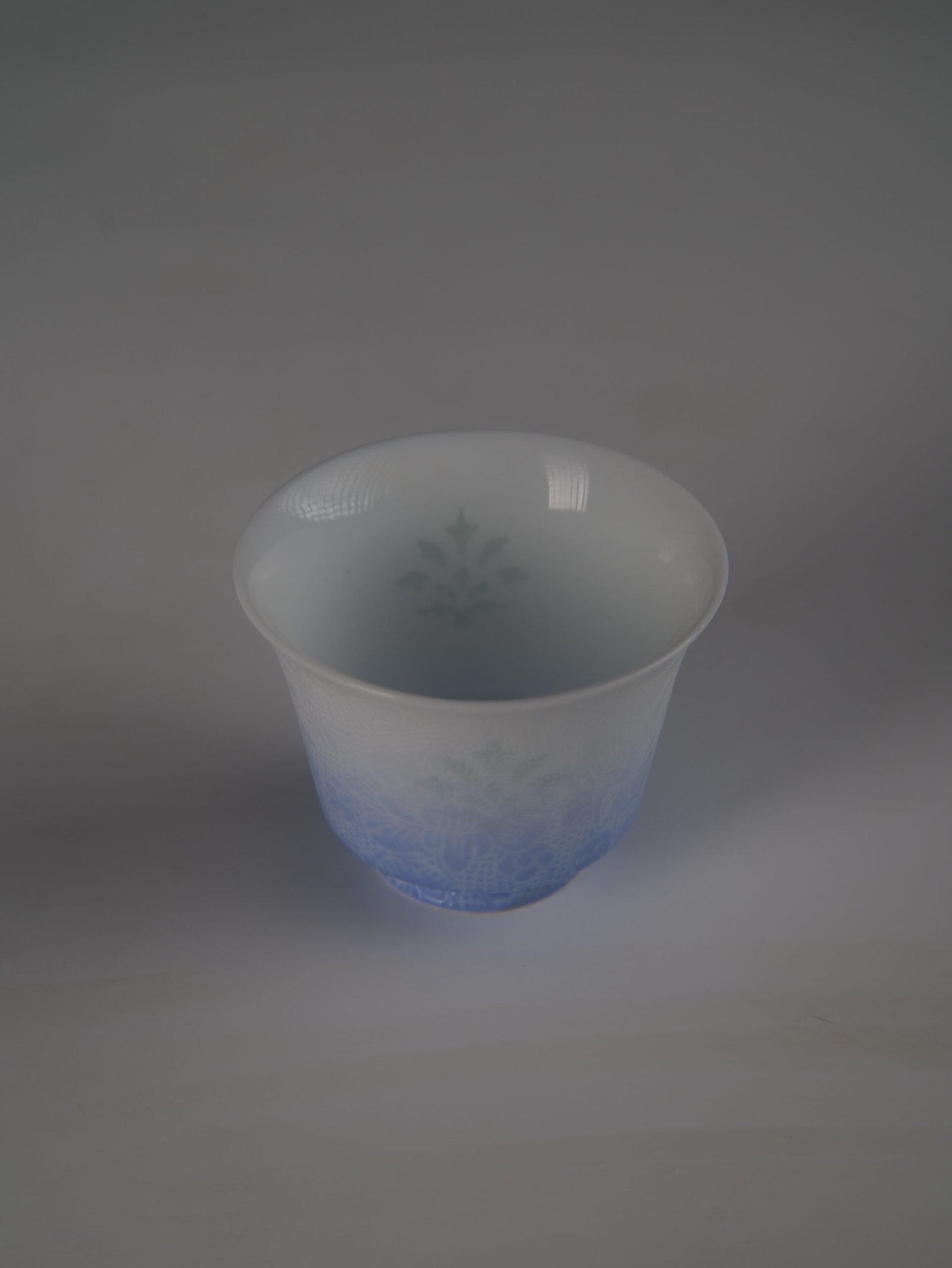 east-breaking-dawn-gradient-blue-horseshoe-porcelain-cup-top-interior-view Top-down view of the East Breaking Dawn gradient blue horseshoe porcelain cup showing the smooth rim and translucent interior pattern