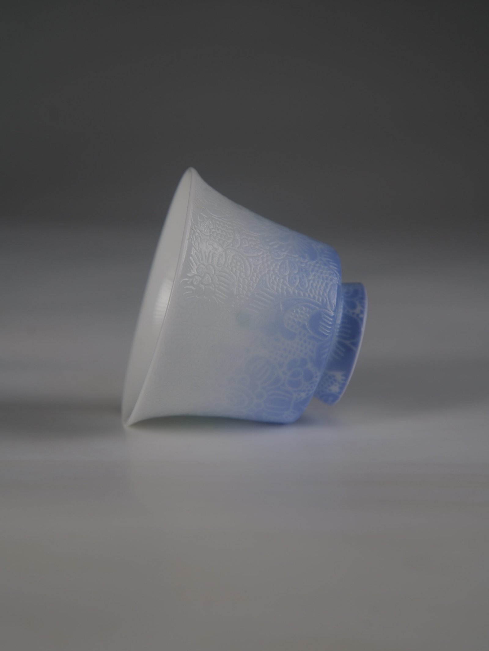 east-breaking-dawn-gradient-blue-porcelain-mug-side-handle-view Side view of the East Breaking Dawn gradient blue porcelain mug with a comfortable handle and carved geometric petal patterns