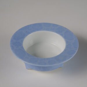 Top angled view of open light blue ceramic incense burner showing white interior