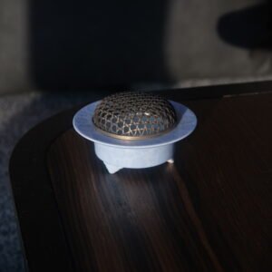 Angled view of light blue ceramic incense burner on dark wooden table