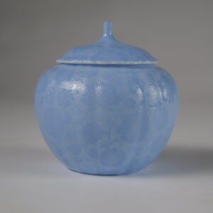 Eye level front view of east breaking dawn blue melon-shaped jar with hundred flowers pattern