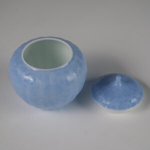 High angle view of open east breaking dawn blue melon jar showing white glazed interior