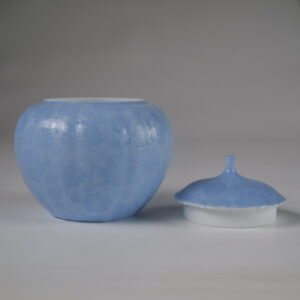 Front view of open east breaking dawn blue melon jar next to porcelain lid