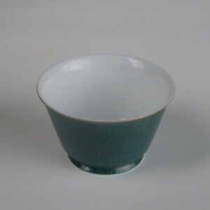 Top-down angle of the Gold base with blue overlay Linked-loop porcelain cup, showing the pristine white interior, fine gold-trimmed rim, and outer carved floral texture