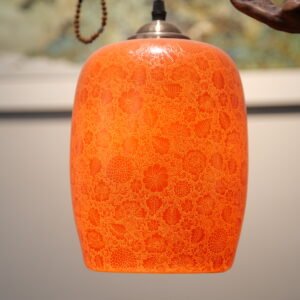 Warm glowing palace red ceramic lampshade creating cozy ambient light
