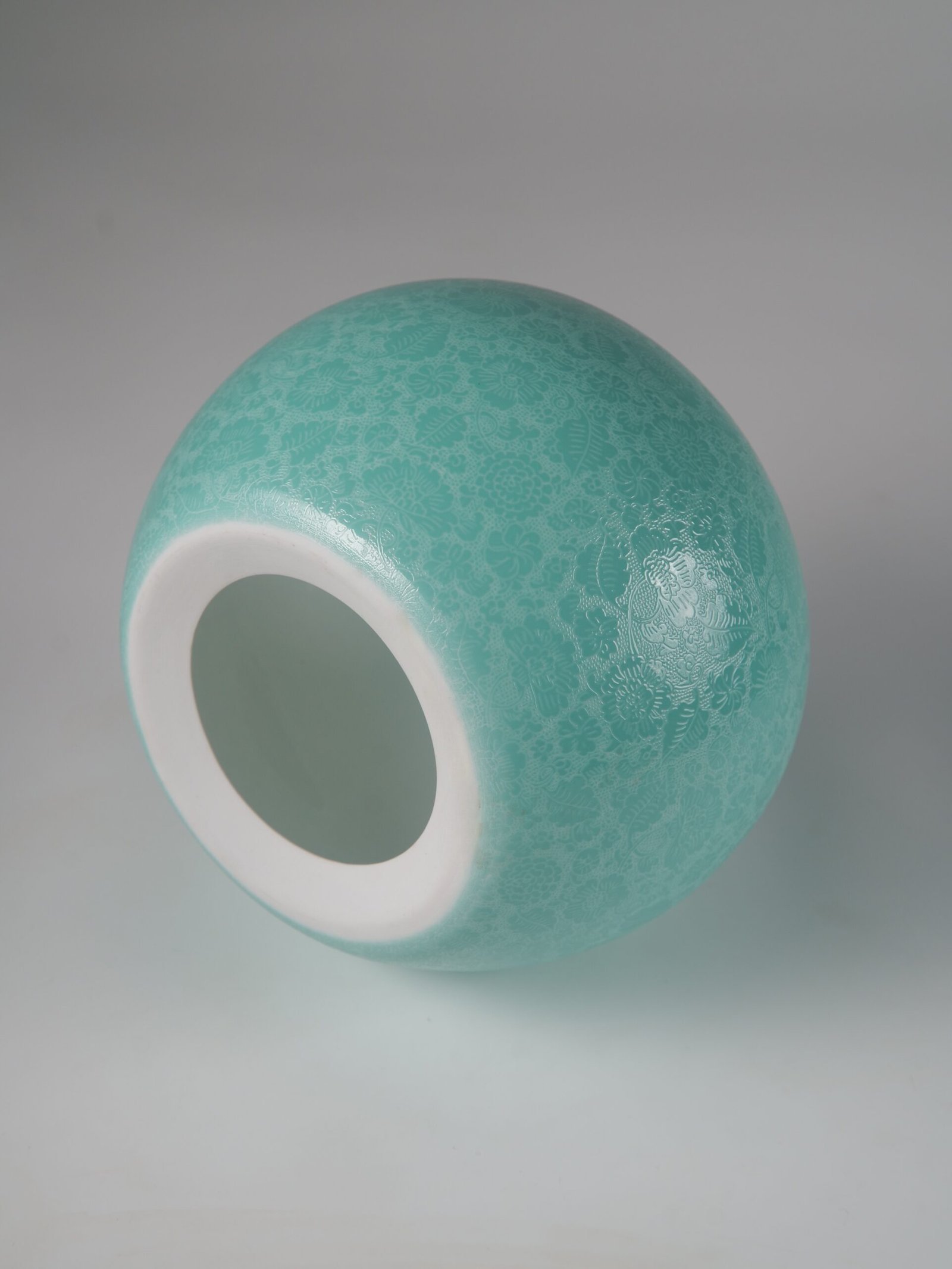 Treasure Jar Lampshade – Top View Top down view of turquoise green carved porcelain lampshade with top opening