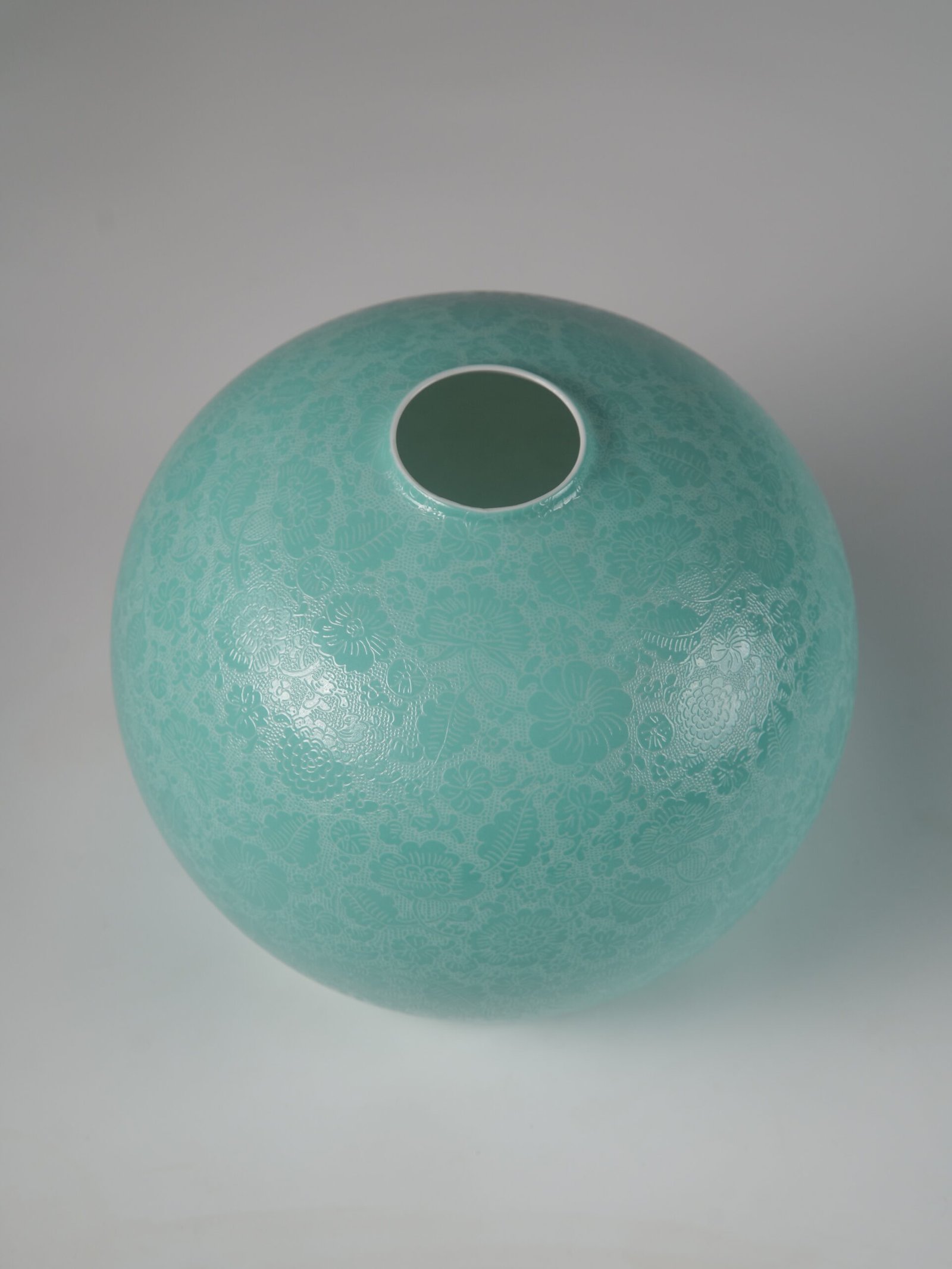 Treasure Jar Lampshade – Surface Texture Close up view of intricate carved floral pattern on turquoise green lampshade