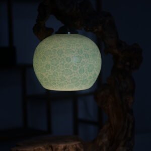 Side view of turquoise green carved porcelain treasure jar lampshade