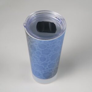 Top down view of blue ceramic travel mug showing clear plastic lid