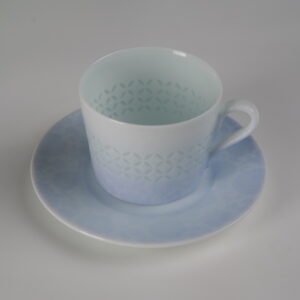High angle view of light blue gradient porcelain cup on saucer