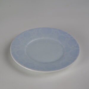 Top view of light blue gradient porcelain saucer with carved pattern