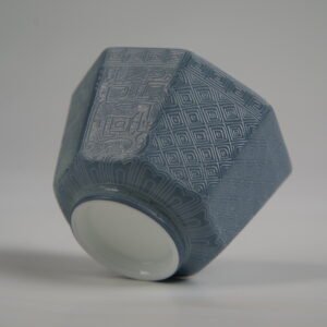 Bottom-up view of the Lunar Gray Octagonal porcelain cup showcasing its white base, geometric octagonal structure, solid lunar gray glaze, and intricate Shang Dynasty Taotie and lattice Pa Hua engravings