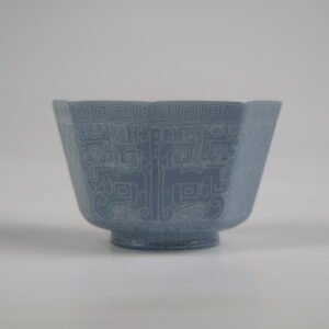 Front view of the Lunar Gray Octagonal porcelain cup displaying its geometric shape, solid lunar gray glaze, and intricate Shang Dynasty Taotie motif with fine carved Pa Hua detailing