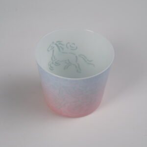 High angle interior view of pastel gradient porcelain cup showing hand-painted green horse motif