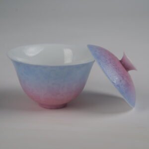 Side view of the Midsummer Dream Gradient Elegant Charm Gaiwan without saucer, showing the lid resting against the cup, white porcelain interior, soft pale purple and pink gradient glaze, and handcrafted Pa Hua floral pattern