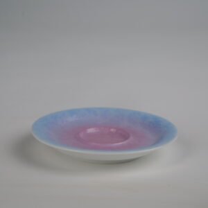 Side angle view of the standalone saucer from the Midsummer Dream Gradient Elegant Charm Gaiwan, showcasing the soft pale purple and pink gradient glaze and intricate hand-carved Pa Hua floral pattern
