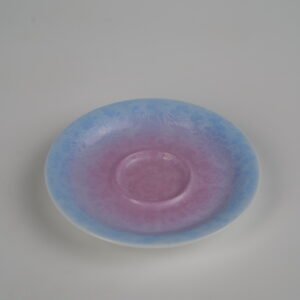 Top-angle view of the standalone saucer from the Midsummer Dream Gradient Elegant Charm Gaiwan, showcasing the soft pale purple and pink gradient glaze and intricate hand-carved Pa Hua Hundred Flowers pattern