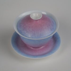 Top-angle view of the Midsummer Dream Gradient Elegant Charm Gaiwan full set, showcasing the soft gradient blend of pale purple and pink glaze on lid and saucer with fine hand-carved Pa Hua Hundred Flowers floral pattern