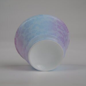 Centered bottom view of the Misty Lavender Haze Linked-loop porcelain cup, showcasing the smooth circular white base and soft purple-blue gradient carved pattern