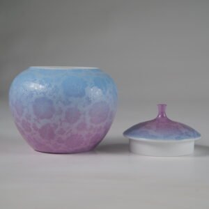 Front view of open misty lavender haze gradient melon jar next to porcelain lid