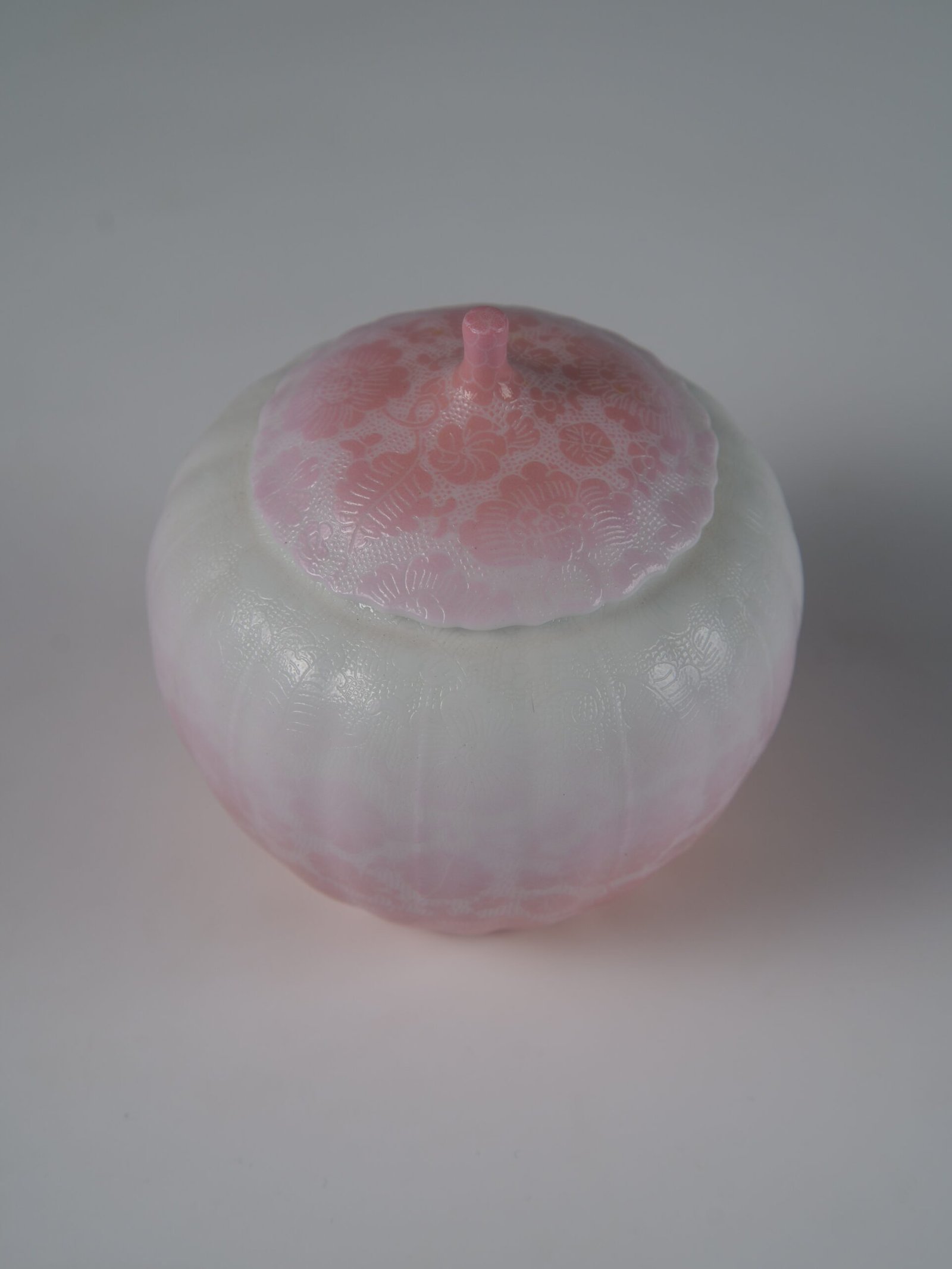 Peach Pink Gradient Melon Jar – Top Angle Top view of peach pink gradient porcelain melon-shaped jar with lid