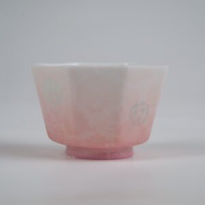 Close-up side view of the Peach Pink Gradient Octagonal Glazed Linglong porcelain cup highlighting its white-to-peach pink gradient tones, fine carved textures, and translucent Linglong rice-grain patterns