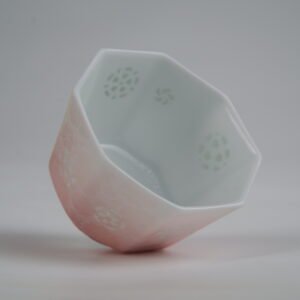 Angled interior view of the Peach Pink Gradient Octagonal Glazed Linglong porcelain cup displaying its geometric octagonal rim, white interior, and translucent rice-grain Linglong holes