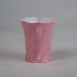 Right side view of peach pink flower-rim fair pitcher with handle and spout