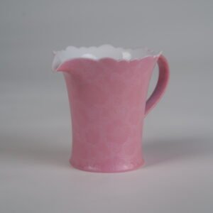 Side profile of peach pink fair pitcher with hundred flowers Pa Hua pattern