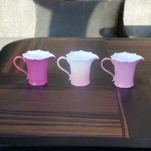 Front view of peach pink porcelain fair pitcher facing the spout