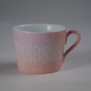 Bright side view of pink gradient porcelain coffee cup