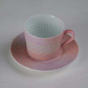 High angle view of pink gradient porcelain cup on saucer