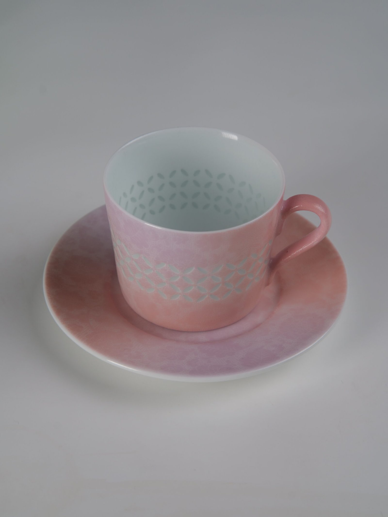 Pink Gradient Coffee Cup – Top Angle High angle view of pink gradient porcelain cup on saucer