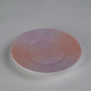 Top view of pink gradient porcelain saucer with floral pattern