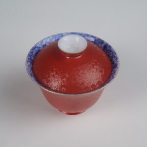 Top-down view of the Palace Red Elegant Charm Gaiwan without saucer, highlighting the blue floral pattern inside the rim and the textured red lid.