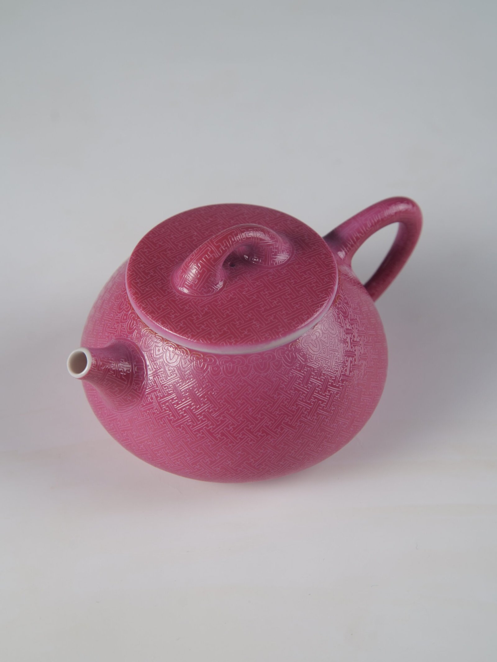 Rouge Red Pa Hua Teapot – Spout and Lid Perspective Angled top view showing the spout and lid of a rouge red porcelain Shi Piao teapot on white background