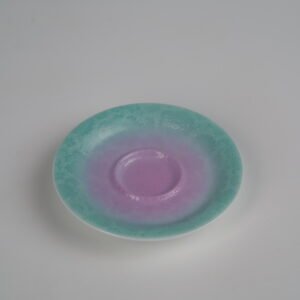 Top-angle view of the standalone saucer from the Spring Glow Gradient Elegant Charm Gaiwan, showcasing the soft pink and fresh green gradient glaze and intricate hand-carved Pa Hua Hundred Flowers pattern