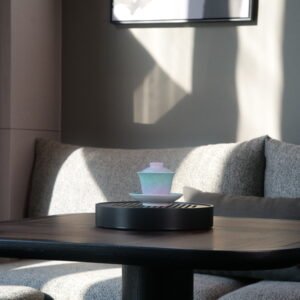 Lifestyle view of the Spring Glow Gradient Horseshoe Gaiwan set on a wooden tea tray under natural sunlight in a modern interior setting