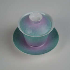 Top-angle view of the Spring Glow Gradient Horseshoe Gaiwan showcasing its lid, cup, and saucer with soft pink-purple and green gradient glaze and fine engraved Pa Hua daylily patterns