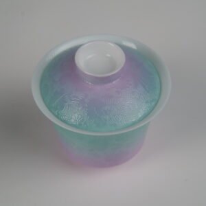 Top-angle view of the Spring Glow Gradient Horseshoe Gaiwan without saucer, showcasing its lid and rim with soft pink-purple and green gradient glaze and fine engraved Pa Hua daylily patterns