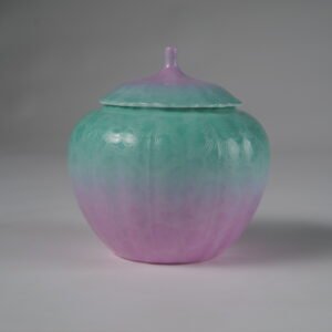 Eye level front view of spring glow gradient melon-shaped tea jar with hundred flowers pattern