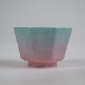 Close-up side view of the Spring Glow Gradient Octagonal Glazed Linglong porcelain cup showcasing delicate carved floral textures and soft green-to-pink gradient colors