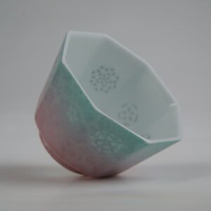 Angled interior view of the Spring Glow Gradient Octagonal Glazed Linglong porcelain cup showcasing its geometric rim, white interior, and translucent rice-grain Linglong perforations