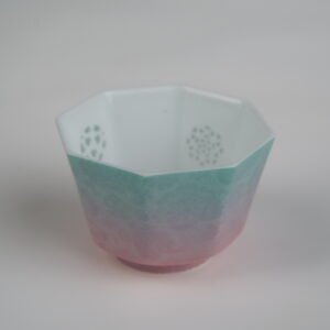 Top-angle view of the Spring Glow Gradient Octagonal Glazed Linglong porcelain cup displaying its octagonal rim, translucent Linglong rice-grain holes inside, and green-to-pink gradient glaze