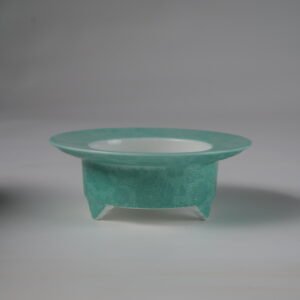 Top angled view of open turquoise ceramic incense burner showing white interior
