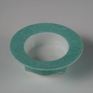 Side view of turquoise three-legged ceramic incense burner without lid
