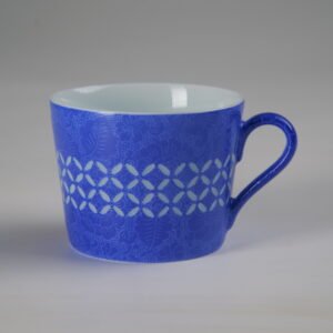 Front view of ultramarine porcelain cup under bright lighting