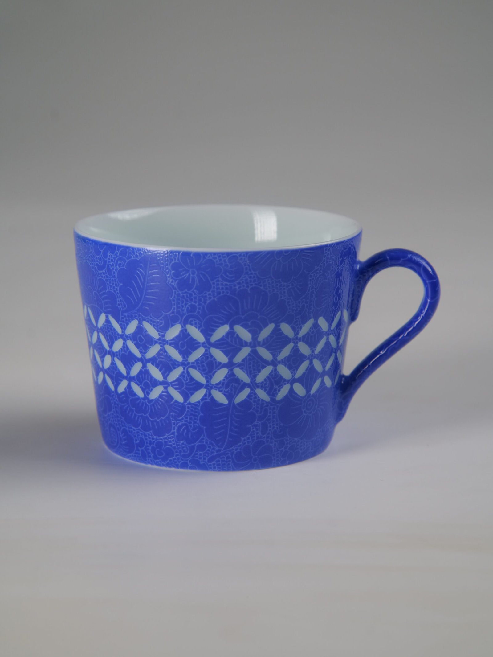 Ultramarine Coffee Cup – Bright Front View Front view of ultramarine porcelain cup under bright lighting